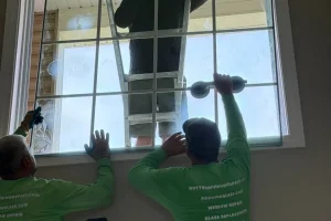 Technicians replacing elevated window glass in Plainfield
